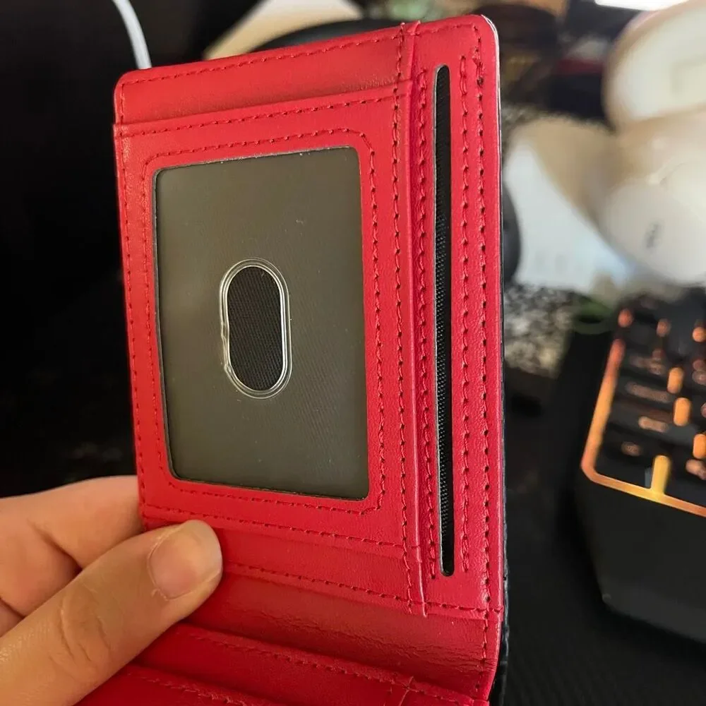 Men’s carbon fiber style wallet with bright red interior.